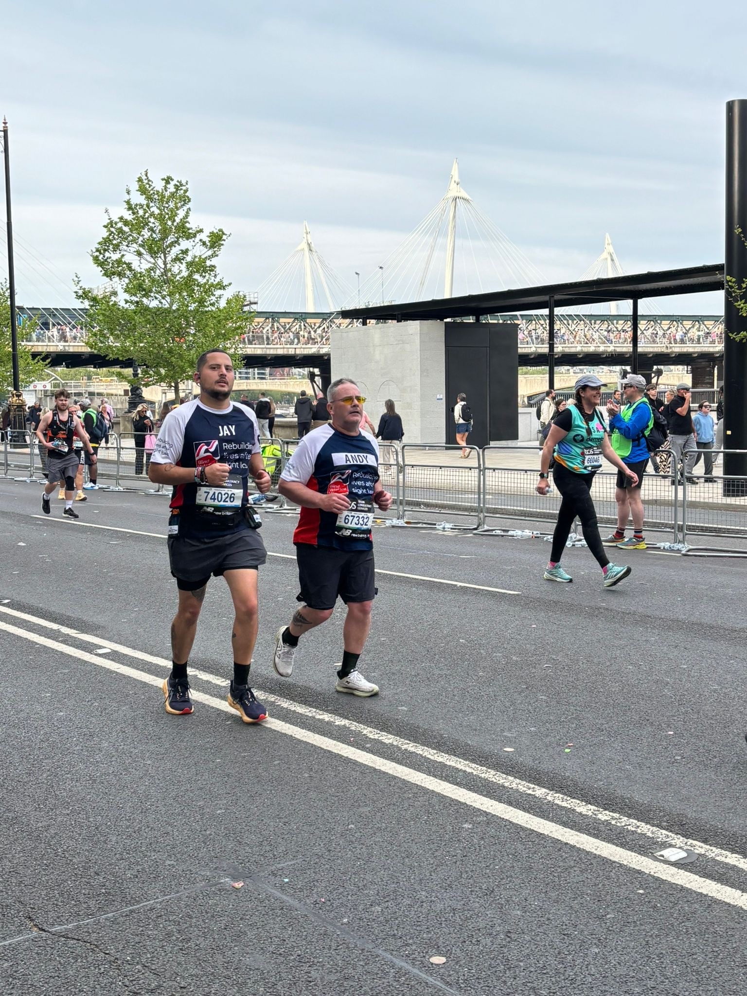 Andy and Jay running side by side both wearing Blind Veterans UK running tops