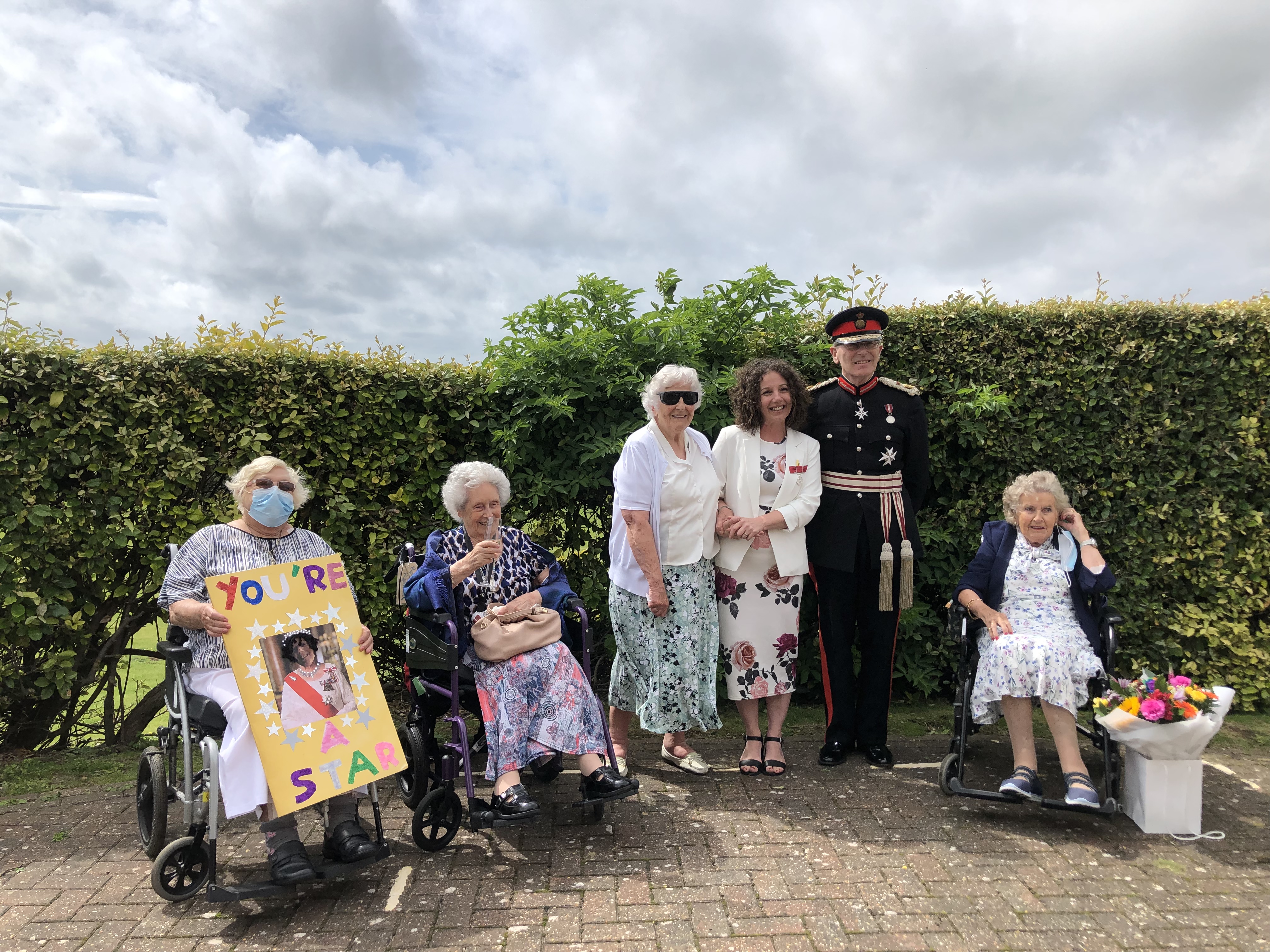 Photo of Blanche, Residential Care Manager with some of our veterans