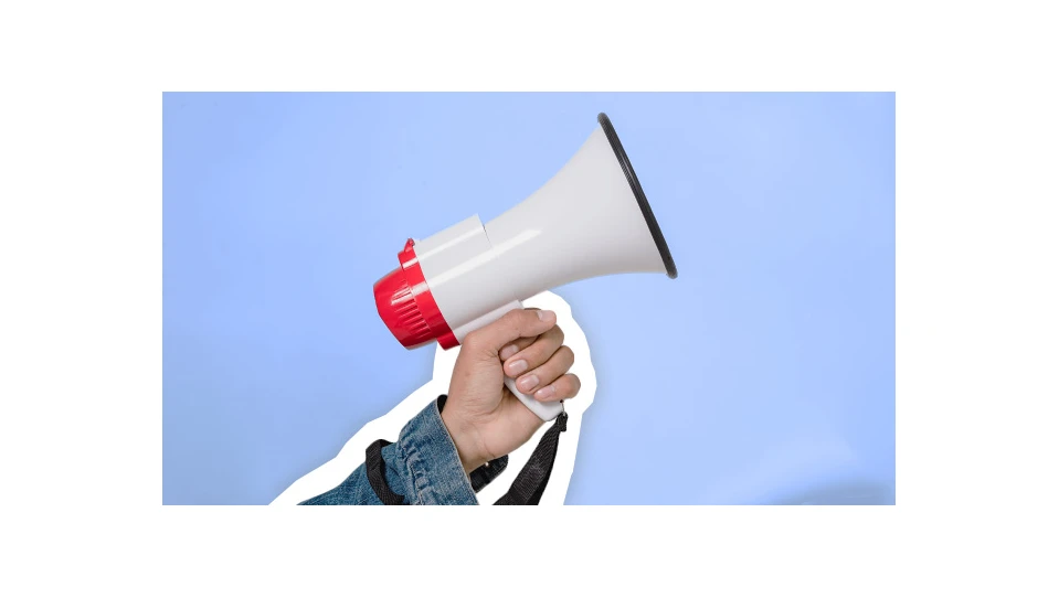 A photo of a hand holding a megaphone