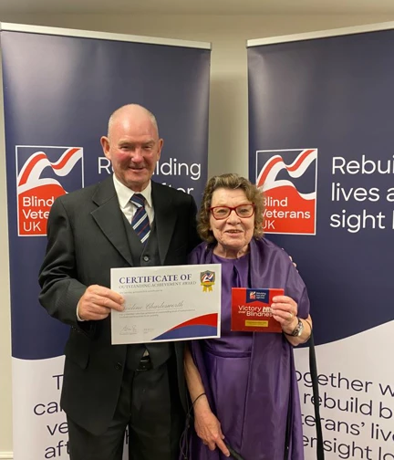Noeline and John holding her certificate at Founder's Awards 2023