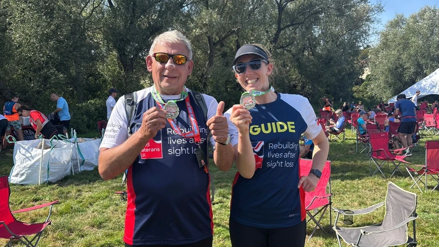 Richard and Theresa in their Blind Veterans UK T-shirts proudly hold up their medals