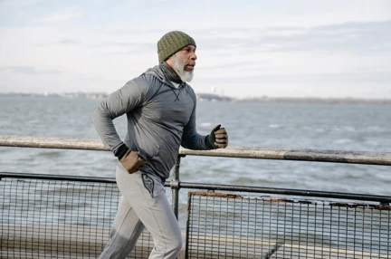 A man jogging by the coast