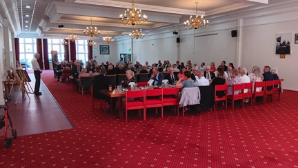 80 guests sat in an 'E' shaped arrangement during the dinner at HMS Sultan. The group are facing the front where James is delivering his talk about D-Day veteran Alec
