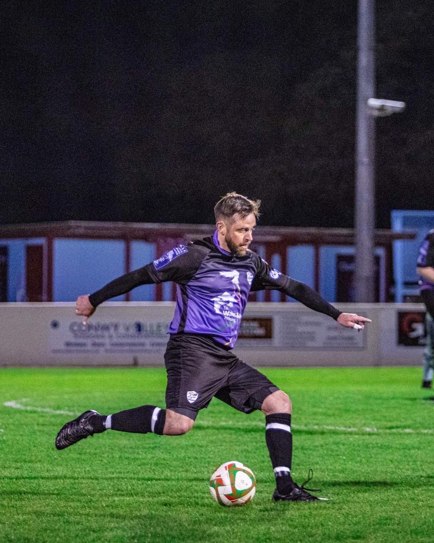 Action shot of Matt in his purple football kit on the pitch