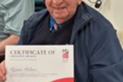 Glynne Proudly Holding Up His Founders Award Certificate
