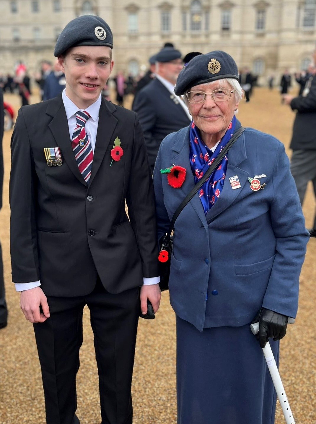 Janet and her Great Grandson both wearing berets and poppies preparing to march at the cenotaph
