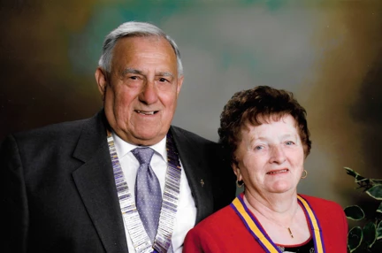 A head-shot of Bob and his late wife dressed smartly, wearing their medals and smiling