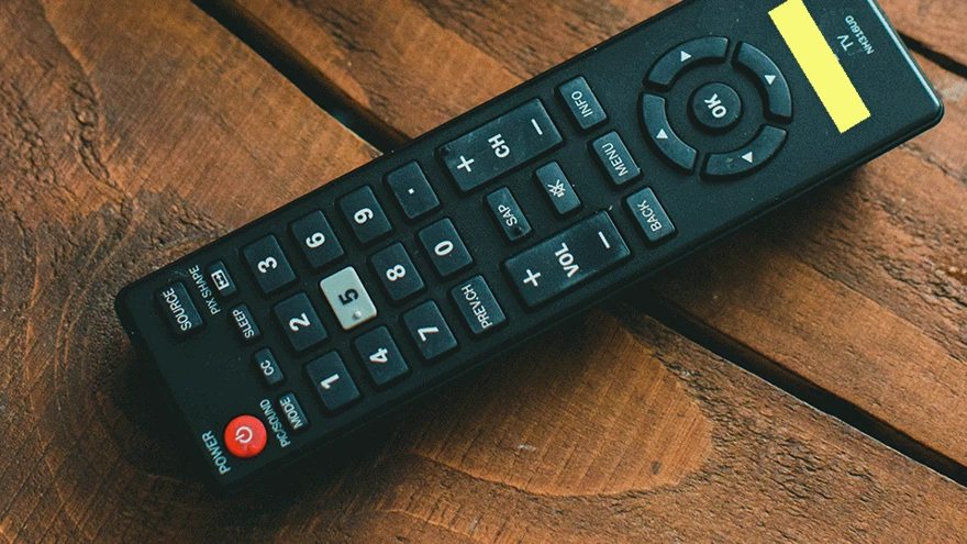 A TV remote with bright yellow highlighter tape