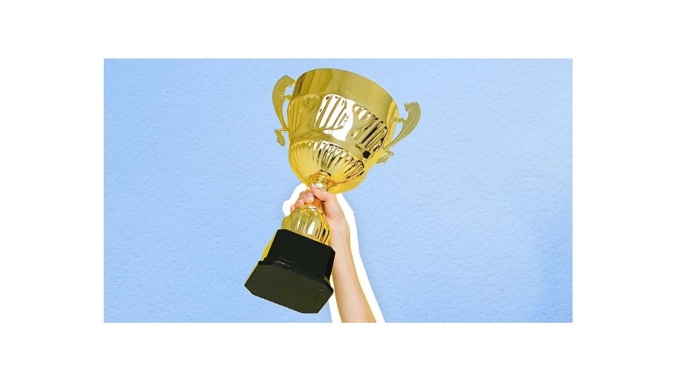A photo of a hand holding a trophy