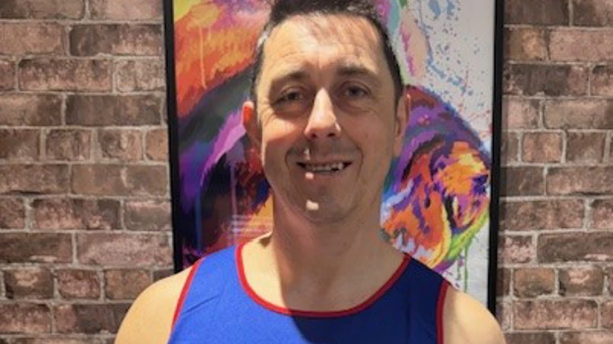 Neil wearing his Blind Veterans UK running top
