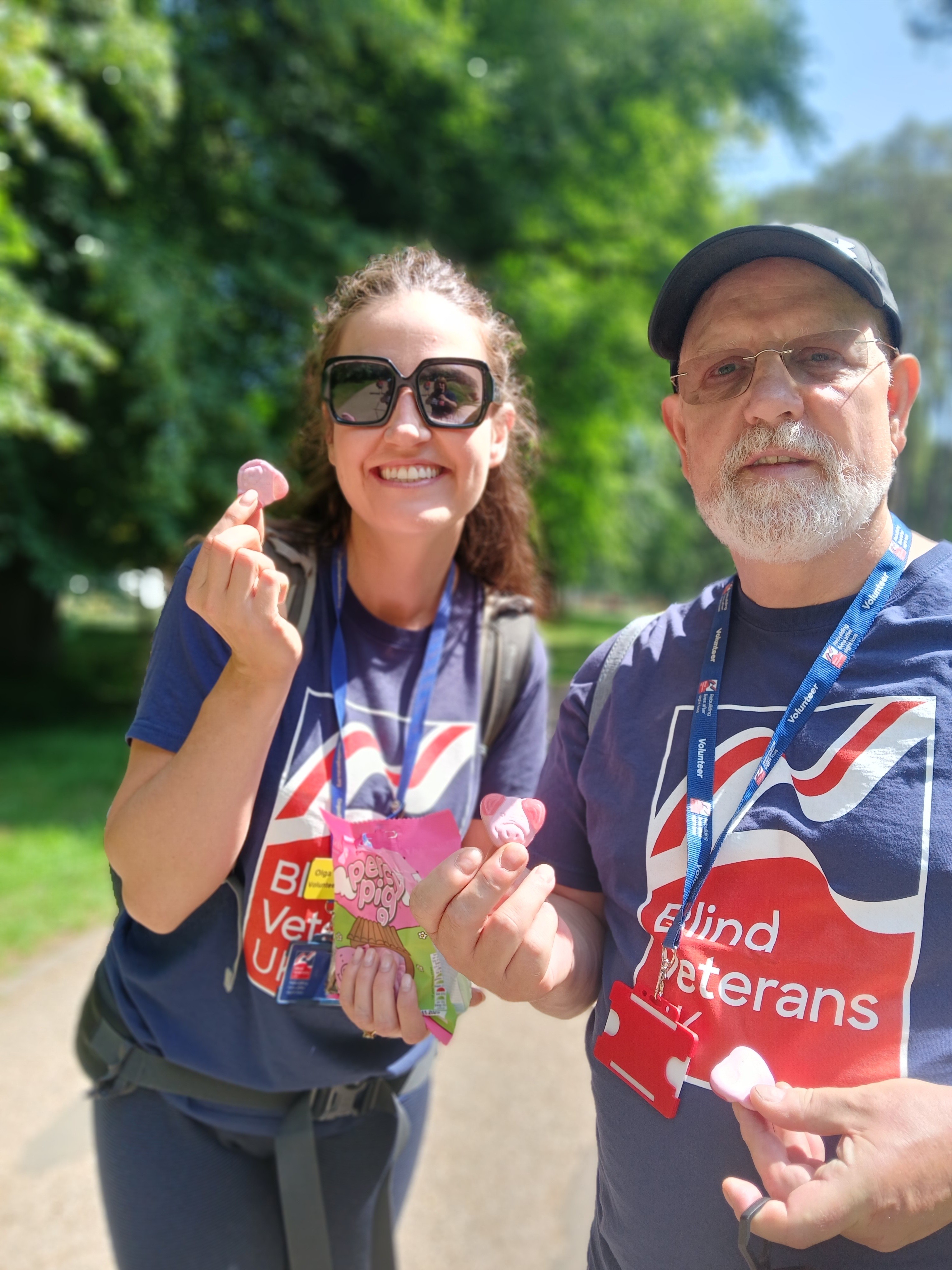 Olga and Phil both in Blind Veterans UK T-shirts stop along the way to eat a bag of sweets