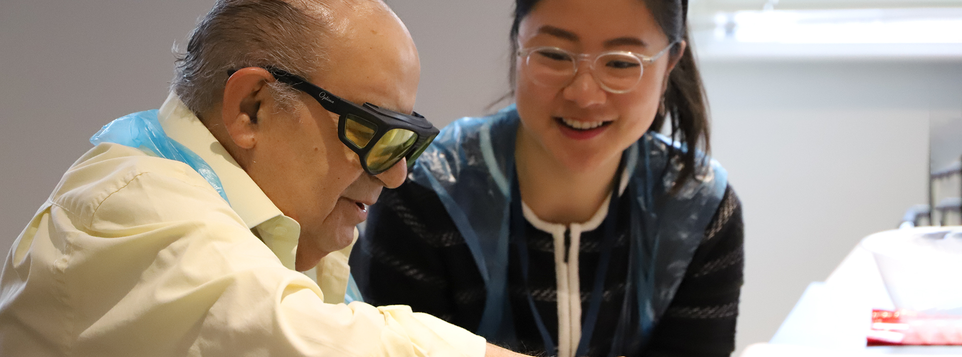 A blind veteran and volunteer smiling at an Easter themed activity day