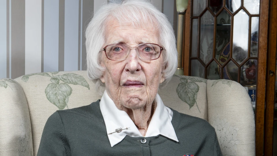 A photo of blind veteran Ruth sitting in a chair