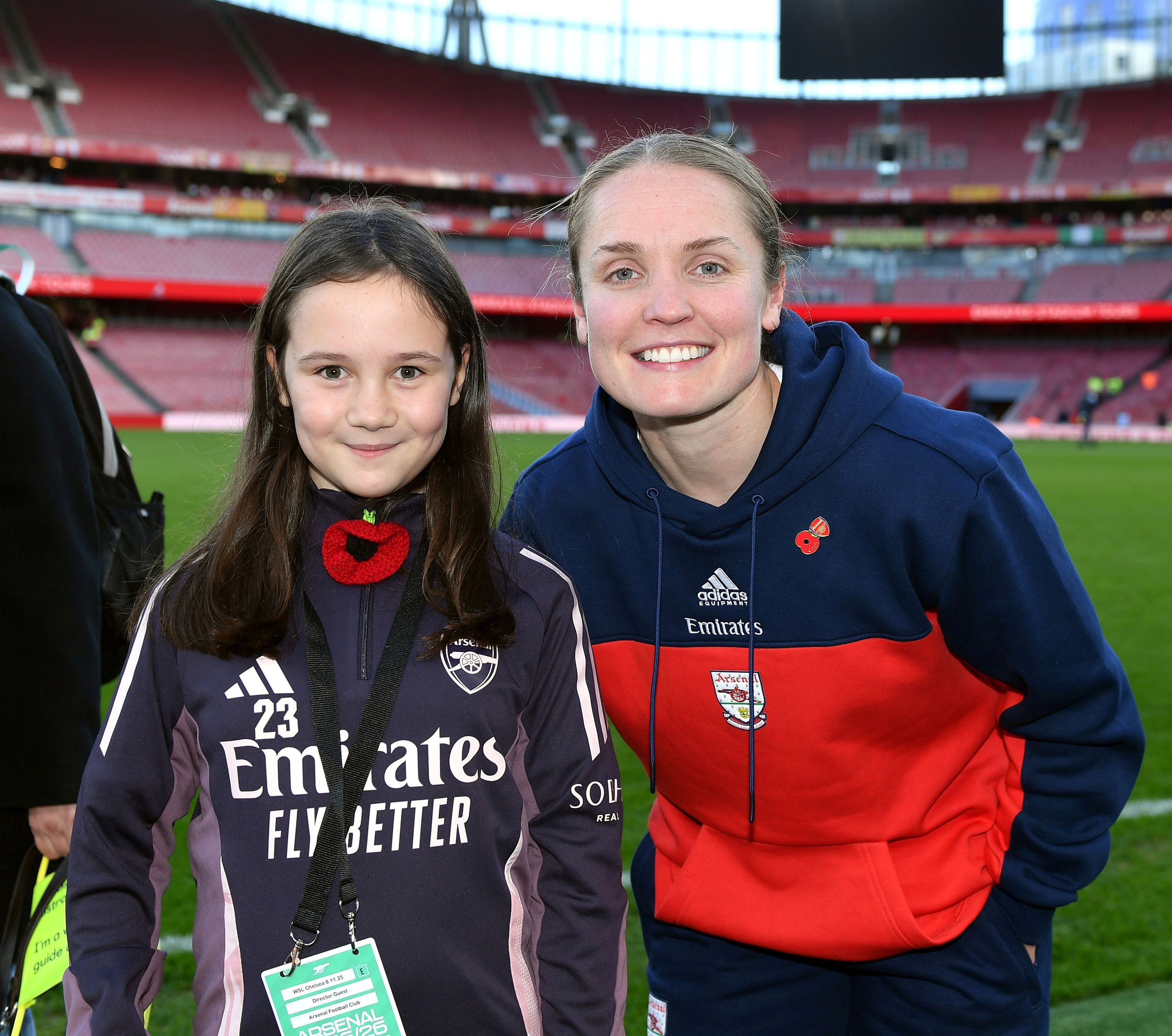 Bethany and Arsenal captain Kim Little pose for a photo at the edge of the pitch at the Emirates Stadium. Huge smiles on both their faces.