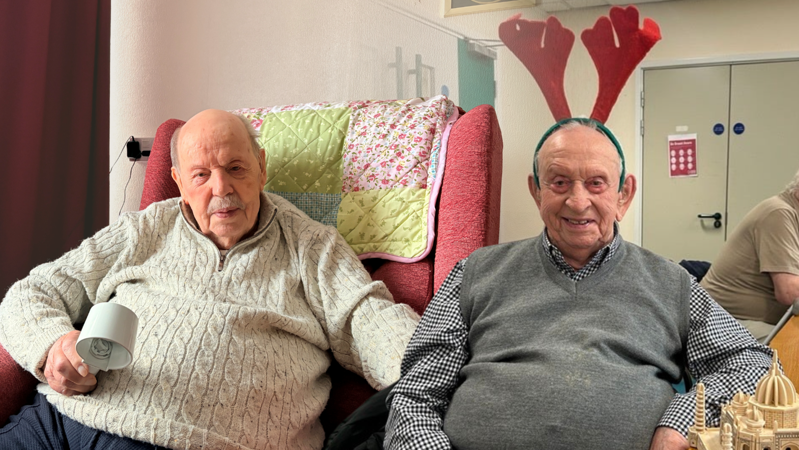 Photo of two male blind veterans, Glynne on the right is wearing red antlers