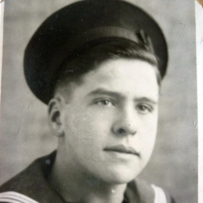 Thomas in service wearing a navy uniform