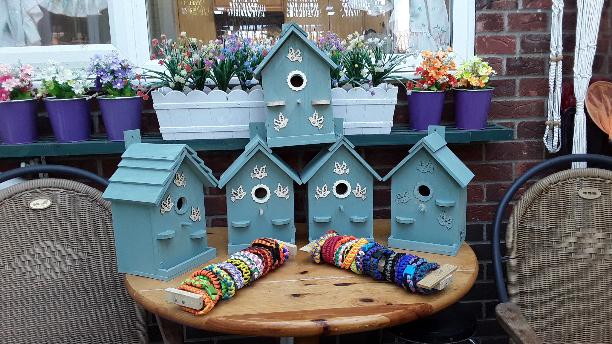 A selection of blue birdhouses and bracelets made my Brian
