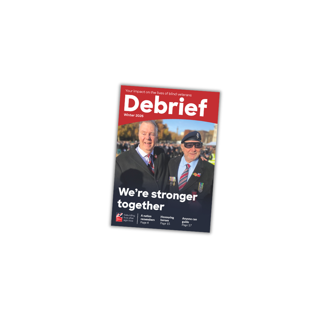 Front cover of Blind Veterans UK’s Debrief magazine, Winter 2026 edition, showing two veterans standing together at the Cenotaph wearing medals. The headline reads: “We’re stronger together”.