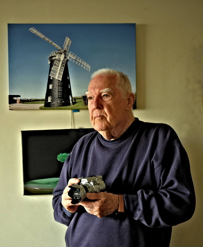 Brian stood up holding his camera