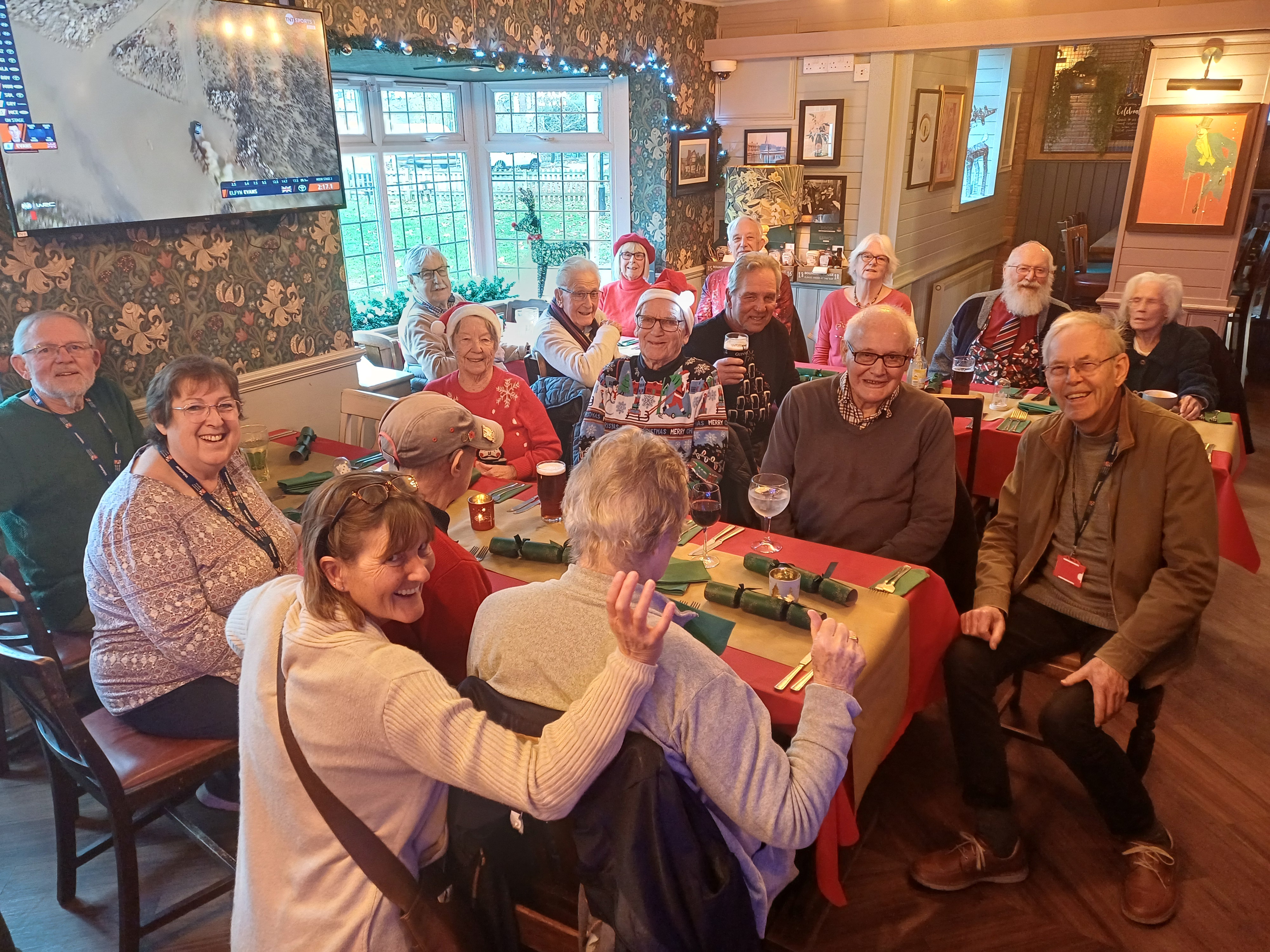 A group of veterans gather in a pub and pose for a photo