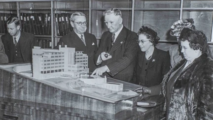The scale model of the Brighton centre, with blind veterans gathered round