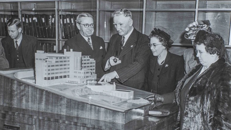 The scale model of the Brighton centre, with blind veterans gathered round