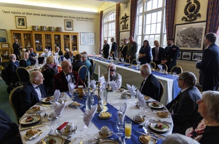 Members and guests at the HMS Drake Military Dinner sitting at round tables and dressed formally
