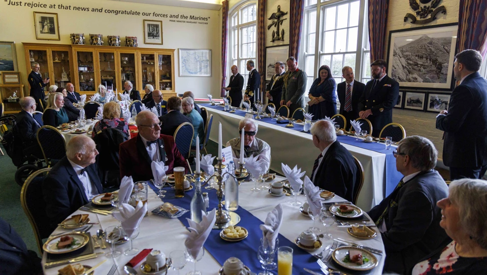 Members and guests at the HMS Drake Military Dinner sitting at round tables and dressed formally