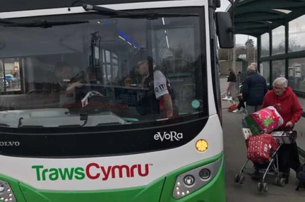 Tony on a Traws Cymru bus talking to the bus driver