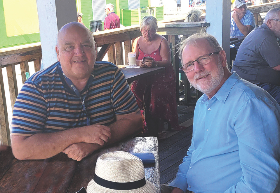 Brothers and blind veterans John And Tom are sitting together in the sunshine, smiling