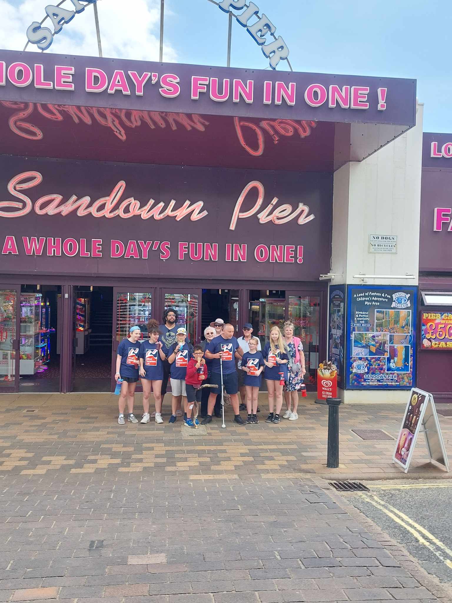 The group of walkers pose for a picture at Sandown Pier