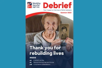 Supporter magazine front cover, with title "Thank you for rebuilding lives" and a photograph of a blind veteran holding up a photograph of her in the military