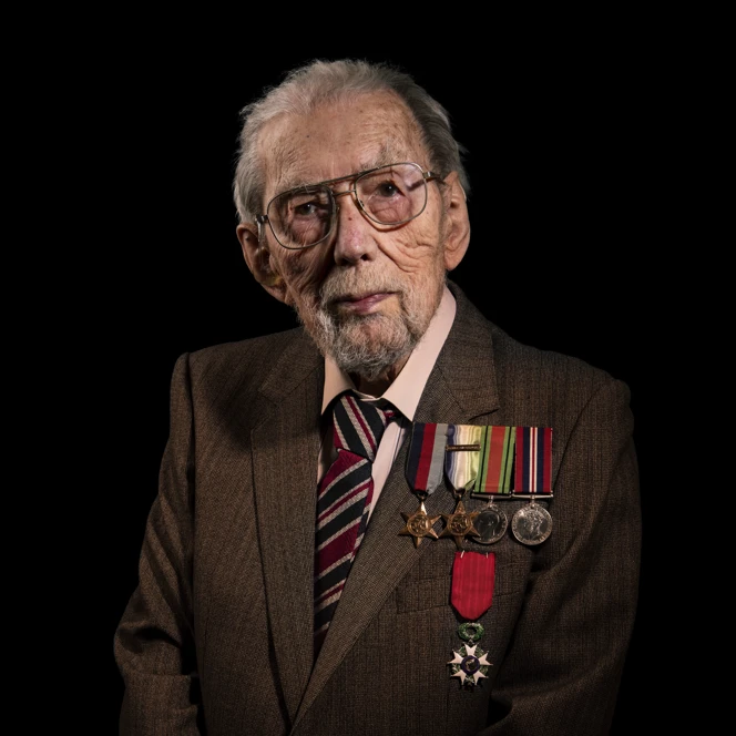 A portrait of John on a black background