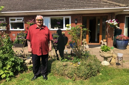 Danny stood in his garden surrounded by plants
