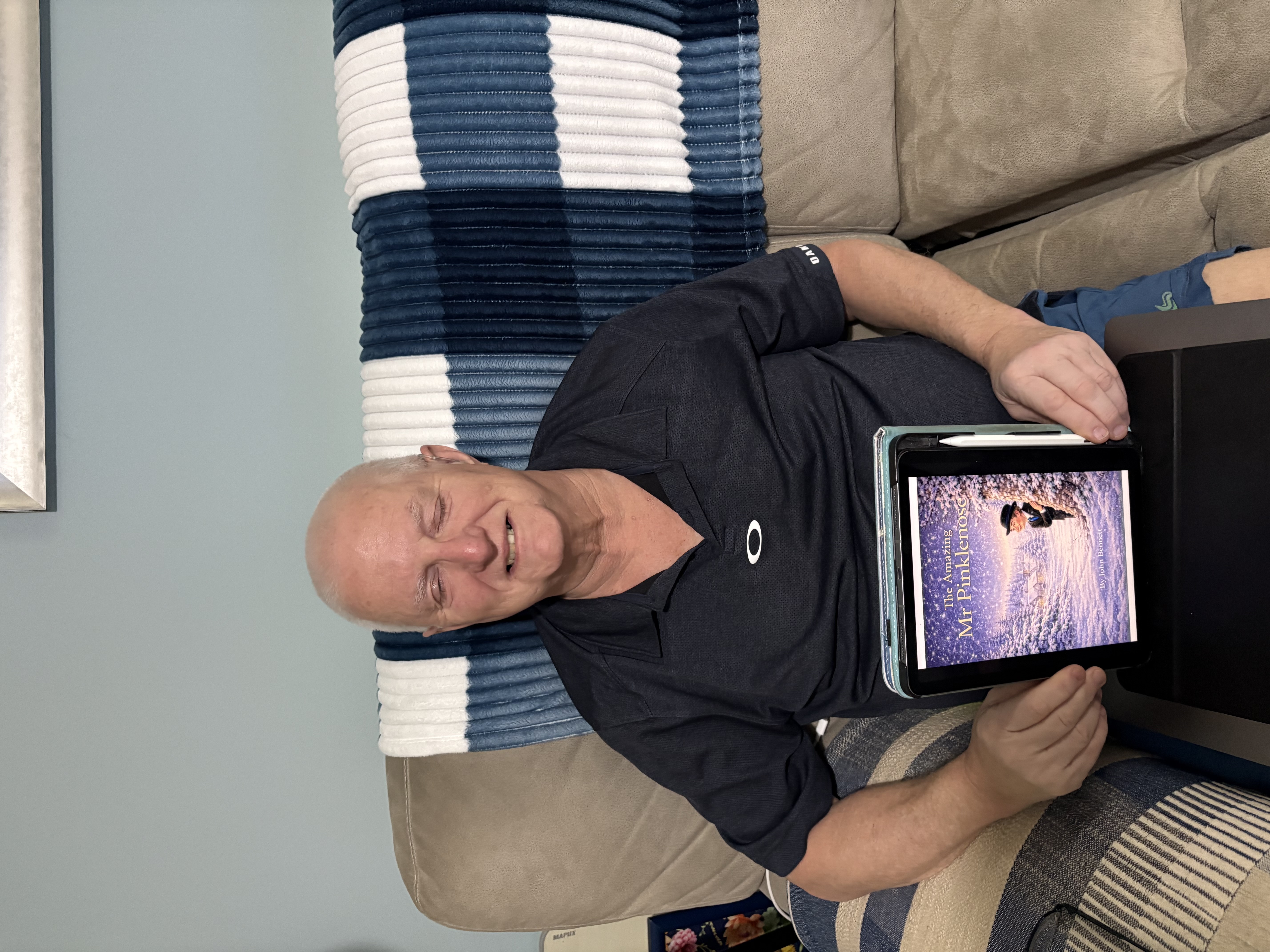 John is sat on his sofa and his eyelids are closed due to myasthenia gravis