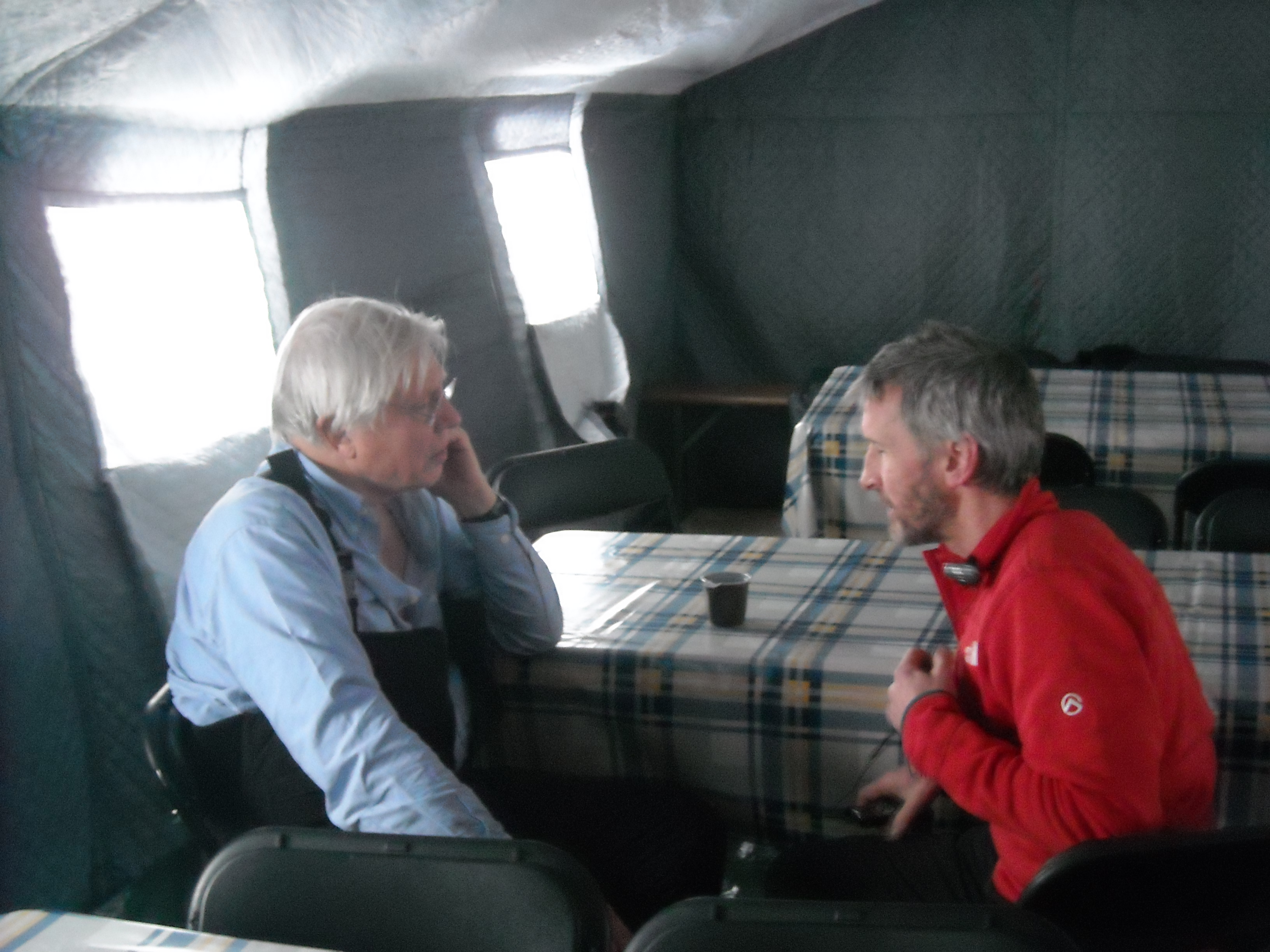 Jamie and Sir David sit opposite each other in a tent and talk