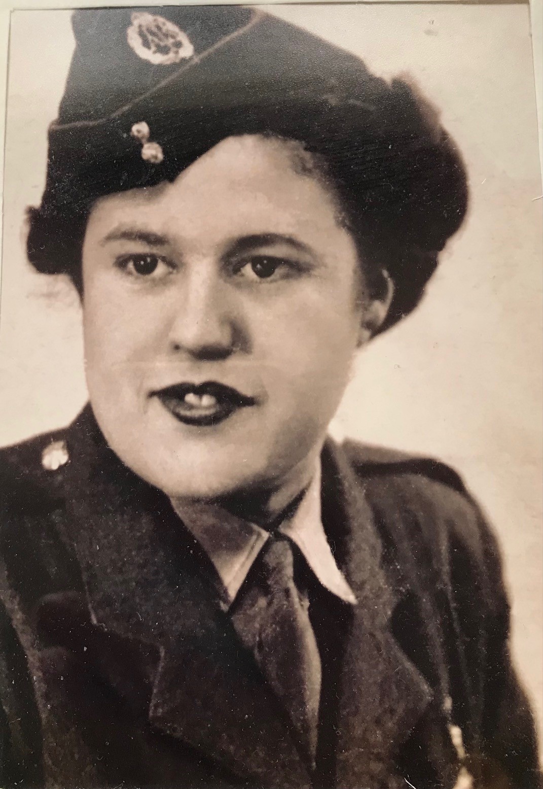 A black and white head-shot of a young Lorna in her Army uniform