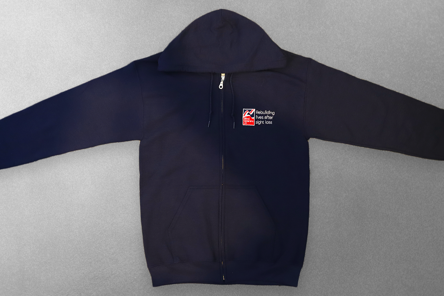 A navy zip hoodie with a Blind Veterans UK logo
