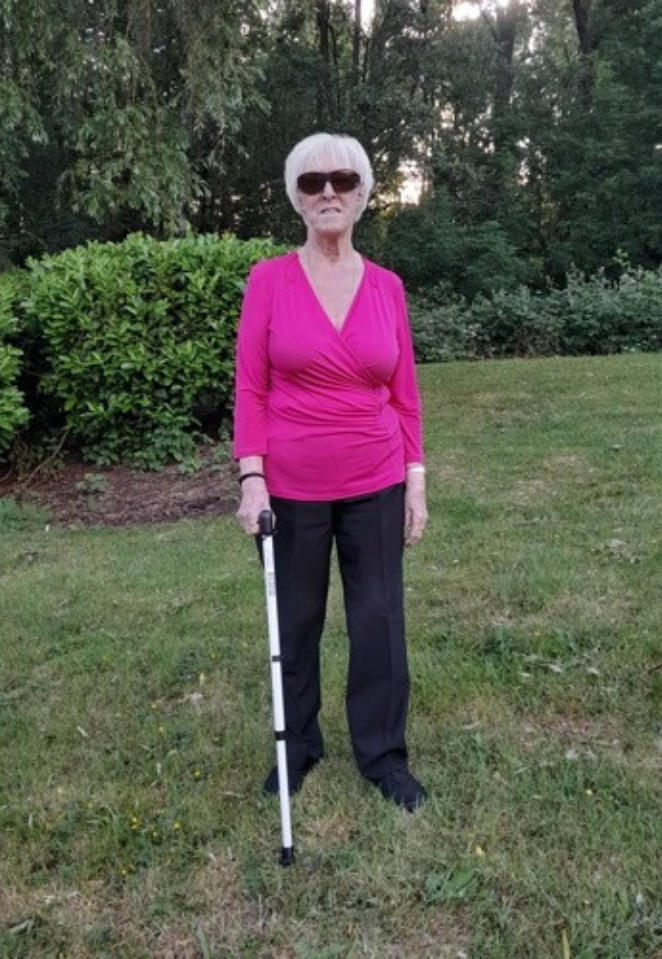 Blind veteran Rene with her cane in her garden.
