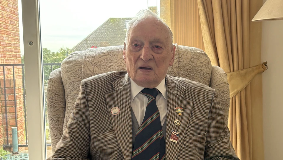 Blind veteran Derrick seated by a window