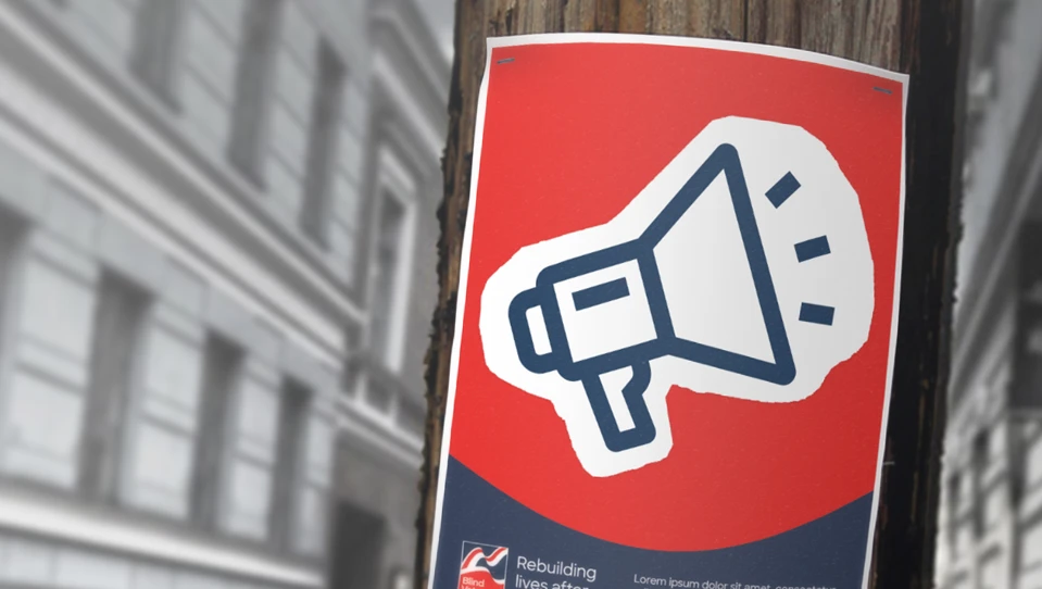 A Blind Veterans UK poster with a large megaphone icon