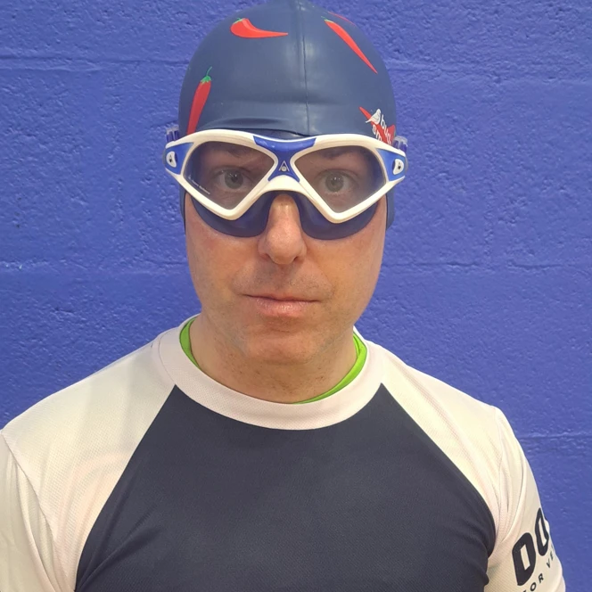 Simon wearing goggles, swimming hat and Blind Veterans UK T-Shirt over the top of his Teenage Mutant Ninja Turtle Costume