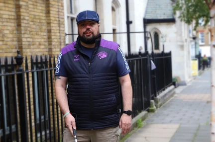 A photo of blind veteran Simon with white cane