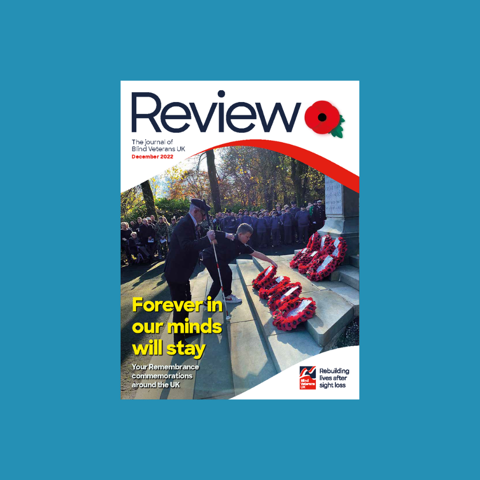 A magazine front cover with title "Forever in our minds will stay" and an image of a blind veteran and young boy laying a wreath at Remembrance