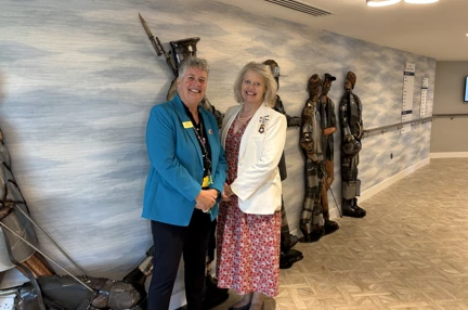 Lesley and Emma are stood in front of the 'Lads' in the Rustington Centre reception