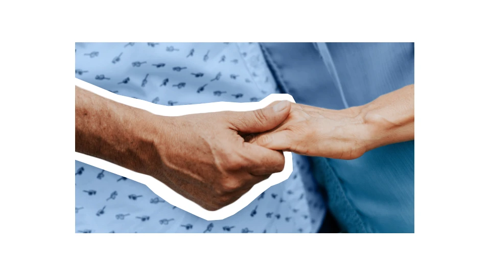 A photo of an older hand holding a younger hand